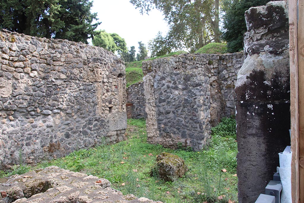 I.1.1 Pompeii. October 2024.
Looking towards south end of east wall, with doorway leading to rear at I.1.10, in centre. Photo courtesy of Klaus Heese.