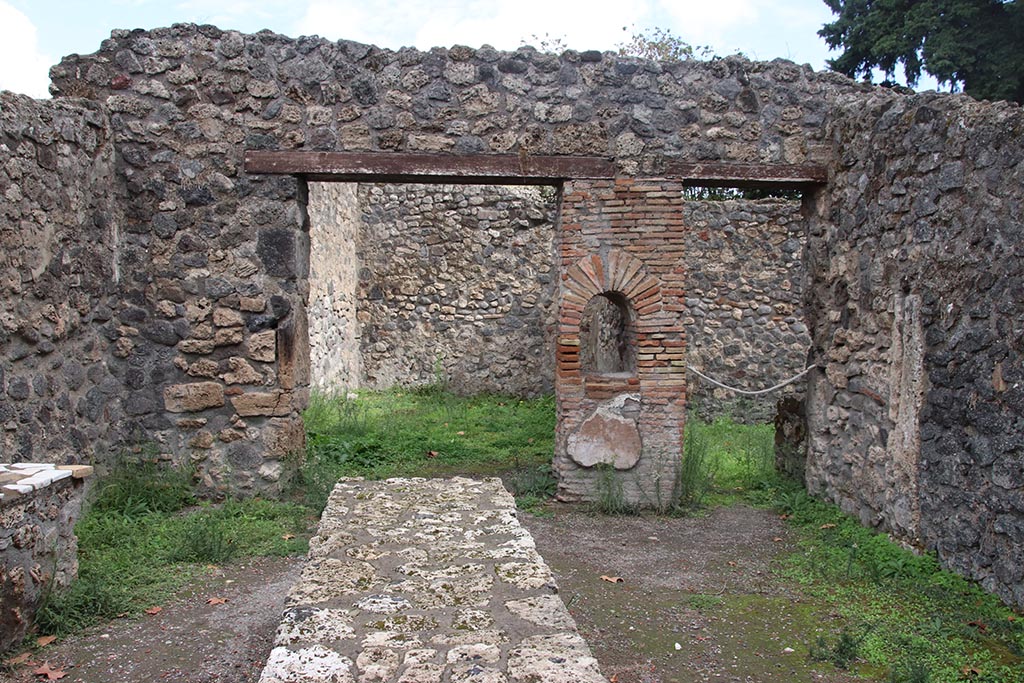 I.1.2 Pompeii, October 2024.
Looking east across bar/selling room with counters. At the rear are entrances to two rear rooms. Photo courtesy of Klaus Heese.