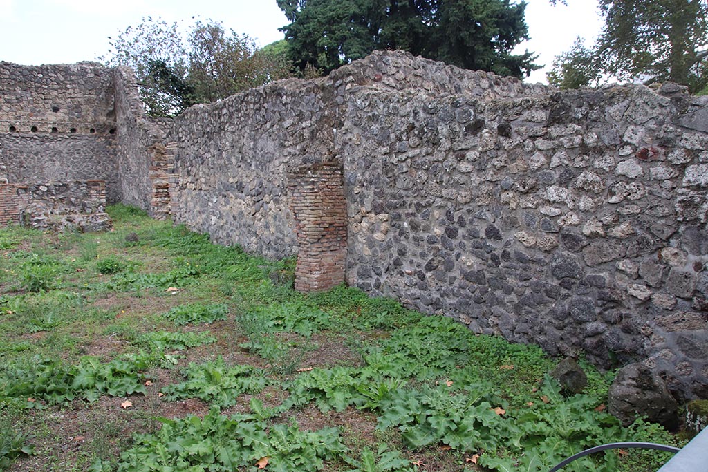 I.1.3 Pompeii, October 2024.
Room “a”, south wall, on right, with south wall of room “b” and yard “c”, centre left, with doorway into room “f” at rear, on left.
Photo courtesy of Klaus Heese.