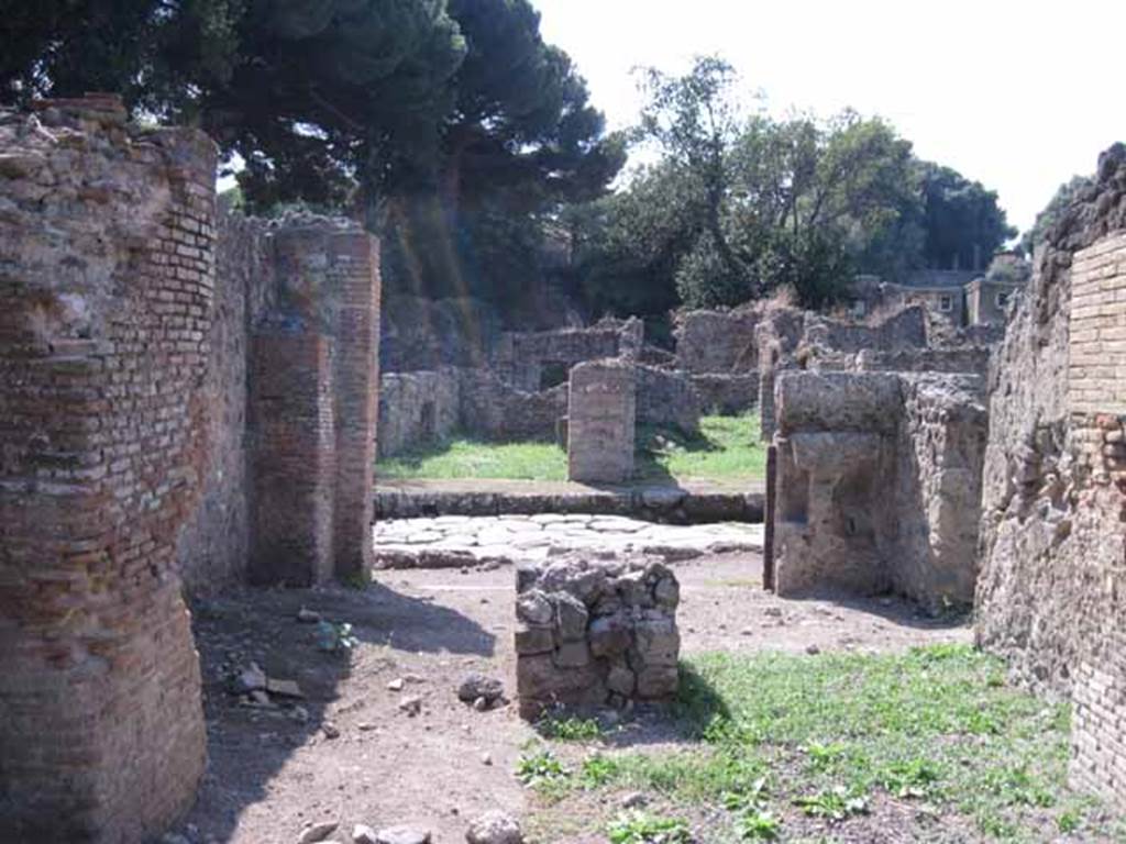 I.1.4 Pompeii. September 2010. Looking west from rear room, across shop-room to Via Stabiana. Photo courtesy of Drew Baker.