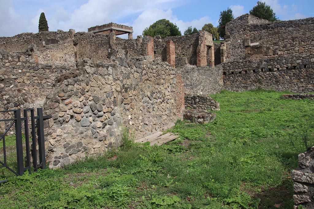 I.1.8 Pompeii. October 2024.
Doorway leading to I.1.9, on left, with north wall of large entrance room, in centre. Photo courtesy of Klaus Heese.