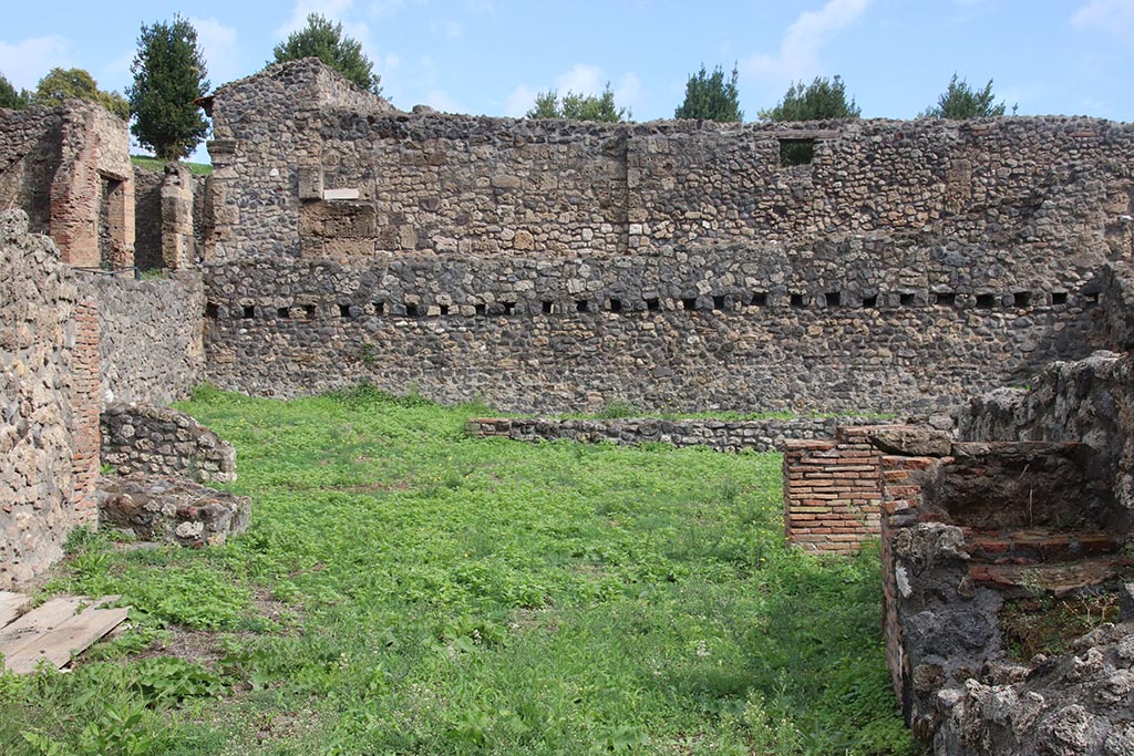 I.1.8 Pompeii. October 2024. Looking towards north-east corner and east wall. Photo courtesy of Klaus Heese.