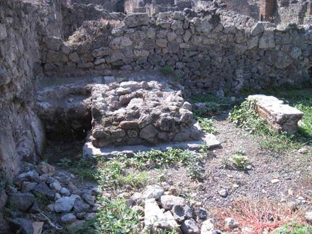 I.1.8 Pompeii. September 2010. Photo courtesy of Drew Baker.
West wall of rear yard, with feature in south-west corner, possibly a masonry watering trough. Looking west. See Mau, A., 1907, translated by Kelsey, F. W., Pompeii: Its Life and Art. New York: Macmillan. (p. 401-2).