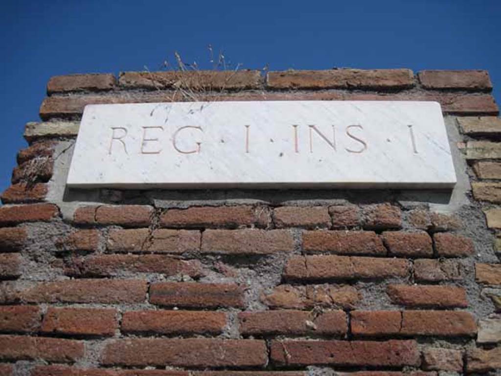 I.1.9 Pompeii. September 2010. ID Plate on end pilaster of insula.
Photo courtesy of Drew Baker.