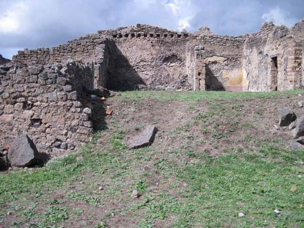 1.2.3 Pompeii. September 2010. Looking north towards remains of middle part of north wall of atrium. The north wall of house at I.2.6 is visible at the rear. Photo courtesy of Drew Baker.
In this area (bombed in 1943) would have been the site of the two cubicula mentioned by Fiorelli. In one of them, he said, was antique decoration under the more recent restoration. The other contained two paintings, Polyphemus and Galatea and Ariadne abandoned by Theseus.
According to Fiorelli, there was a third painting which had been destroyed. Included on the walls were painted medallions enclosed in circles of wreaths of leaves, which were still visible. In one were Mars and Venus, in another Meleager and Atalanta, and in third was the head of a Bacchante. On the wall to the right was a small hollow covered internally with marble, probably to hold a lantern.
See Pappalardo, U., 2001. La Descrizione di Pompei per Giuseppe Fiorelli (1875). Napoli: Massa Editore. (p.34)
See Garcia y Garcia, L., 2006. Danni di guerra a Pompei. Rome: L’Erma di Bretschneider. (p.38, no.21 for photo of wall with Polyphemus and Galatea).
According to Warscher’s list from Prof.Sogliano, the paintings listed were all from the third cubiculum to the left of the atrium. Head of Bacchante, no. 199 on p.45,
Polyphemus and Galatea, no. 474 on page 78, Heads of Atalanta and Meleager, no. 507 on page 89, Ariadne abandoned by Theseus, no.534 on page 97, Heads of Mars and Venus, no 605; and a female head (this one nearly all destroyed) no.606, on page 124).
See Warscher T., 1935. Codex Topographicus Pompeianus: Regio I.2. Rome: DAIR (after photo no.12).
See Sogliano, A., 1879. Le pitture murali campane scoverte negli anni 1867-79. Napoli: (p. 45, 78, 89, 97, 124)