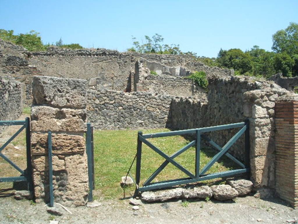 I.2.5 Pompeii. May 2005.
Looking east across shop bombed in 1943, only the external rebuilt walls remain.
According to Eschebach, it contained a shop-room, two rustic rear rooms and a latrine.
See Eschebach, L., 1993. Gebäudeverzeichnis und Stadtplan der antiken Stadt Pompeji. Köln: Böhlau. (p.15)