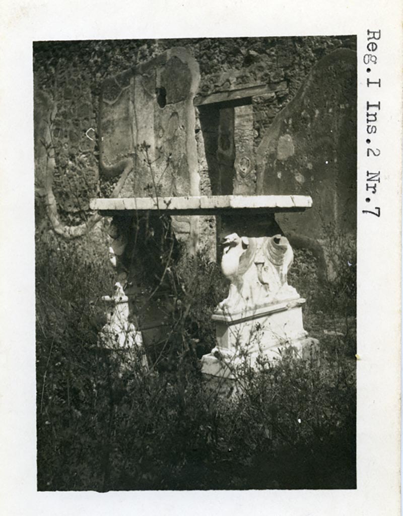 I.2.6 Pompeii but numbered as I.2.7 on photo. Pre-1937-39.
Looking north-east across atrium towards small doorway into portico of peristyle.
Photo courtesy of American Academy in Rome, Photographic Archive. Warsher collection no. 543.