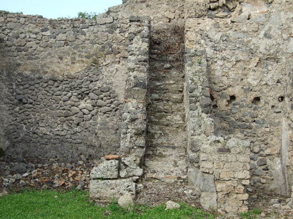 I.2.6 Pompeii. Steps to upper floor and kitchen.
Boyce says that in a small room, perhaps a kitchen on the intermediate floor, reached by stairs on north side of peristyle, was a Lararium.
Below a small arched niche, a rectangular panel was marked off and within it was painted a single serpent advancing left towards the offerings upon an altar: in the background were plants and across the top were festoons.
See Boyce G. K., 1937. Corpus of the Lararia of Pompeii. Rome: MAAR 14. (p.21 no.5)
Note: Found in the kitchen located on the first floor was a bronze statuette of Diana with bow and quiver. Giornale degli Scavi, N.S. III, 1874, 58.