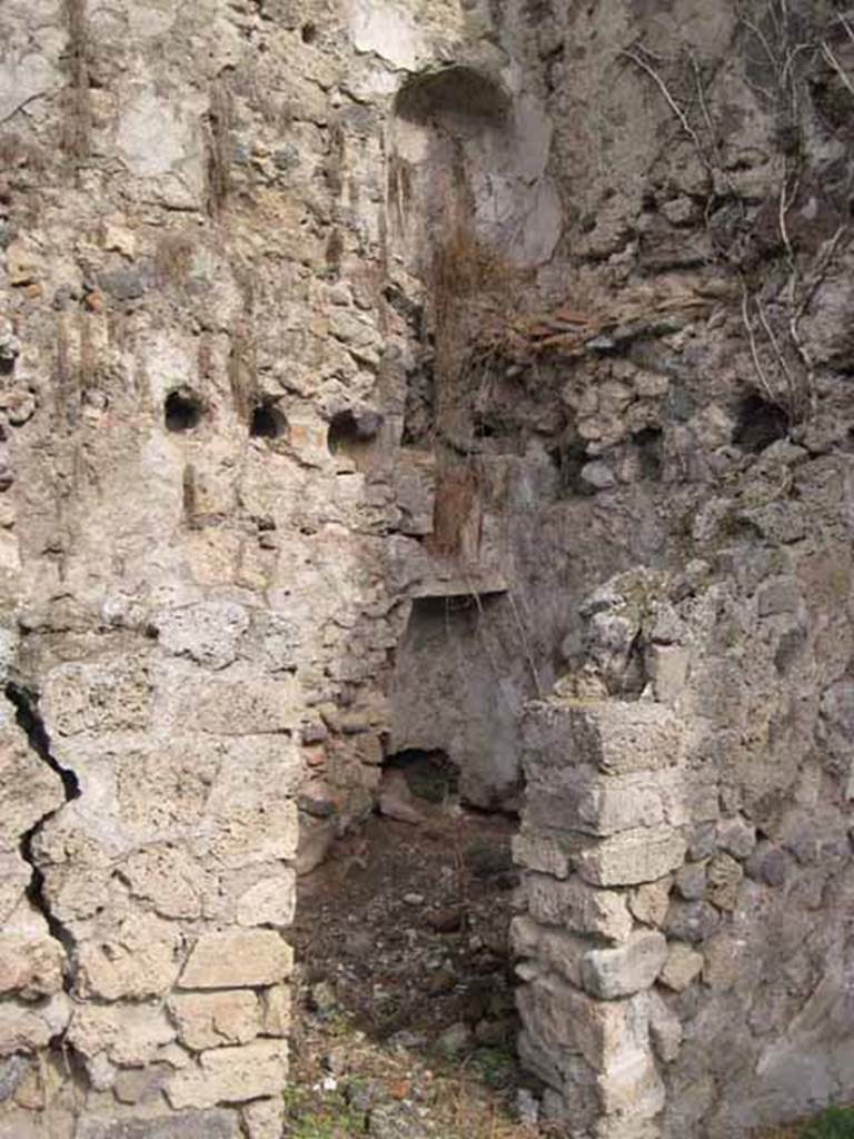 1.2.6 Pompeii. September 2010. Looking north-east through doorway, across small room. In the north-east corner, two recessed features parallel to each other on different floors (latrine nitch?) can be seen on the north wall. Photo courtesy of Drew Baker.