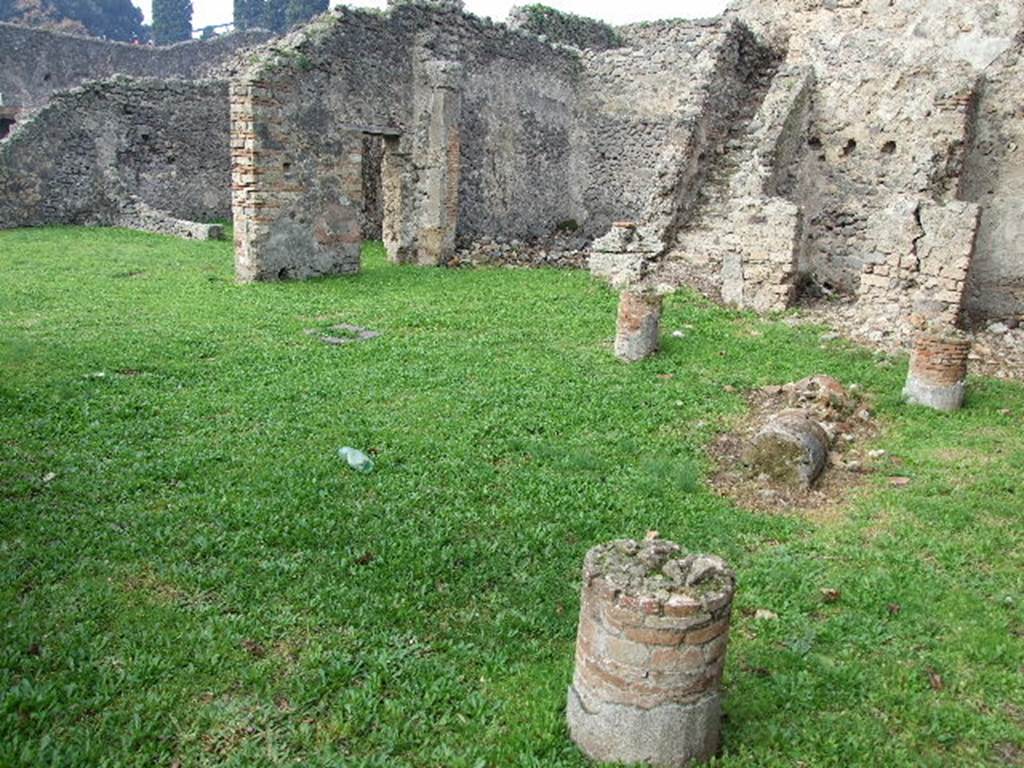 I.2.6 Pompeii. December 2006. Looking north west across peristyle to north side of house, and the atrium. According to Jashemski, the west portico was entered directly from the atrium through the two doors. The garden had a portico on four sides and was supported by eight stuccoed brick columns. See above, now only stumps survive.
See Jashemski, W. F., 1993. The Gardens of Pompeii, Volume II: Appendices. New York: Caratzas. (p.22)