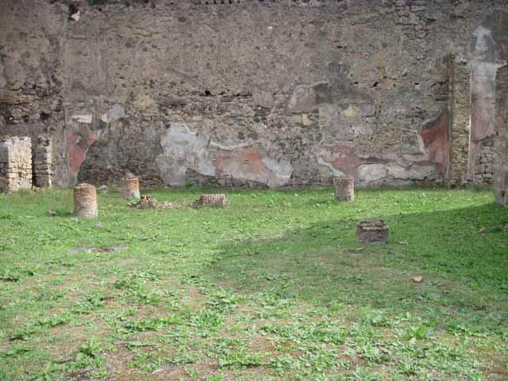 1.2.6 Pompeii. September 2010. East wall of peristyle. Photo courtesy of Drew Baker.
According to Warscher, quoting Mau in BdI, 1874, p.199, she described –
I.2.6 “la pittura delle pareti del peristilio sopra zoccolo nero con ornamenti ci mostra scompartimenti rossi intermediati da altri neri più stretti ne’ quali è dipinto un candelabro giallo e attortigliarto; in mezzo agli scompartimenti rossi vi sono quadretti fatti con poca diligenza e rappresentati maschere e paesaggi”.
See Warscher T., 1935. Codex Topographicus Pompeianus: Regio I.2. (after no.18), Rome: DAIR, whose copyright it remains.
(translation: I. 2.6 "the painting of the peristyle walls above the black zoccolo with ornaments, showed red compartments separated by other more narrow black ones, on which were painted yellow twining candelabra; in the middle of the red compartments there were paintings made with a little diligence and represented masks and landscapes.")