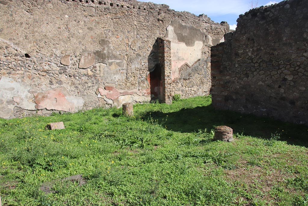 1.2.6 Pompeii. October 2024.
Looking towards south end of east wall of peristyle, and doorway into triclinium. Photo courtesy of Klaus Heese.