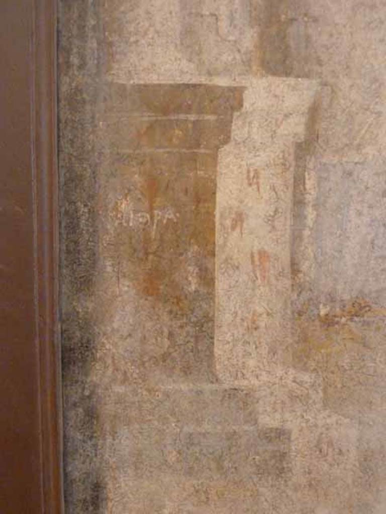 I.2.6 Pompeii. May 2010. Detail from the wall painting of the Theft of the Palladium (Ratto del Palladio) found on the south wall of the triclinium. Column base with name on left side of painting. Now in Naples Archaeology Museum, inventory number: 109751