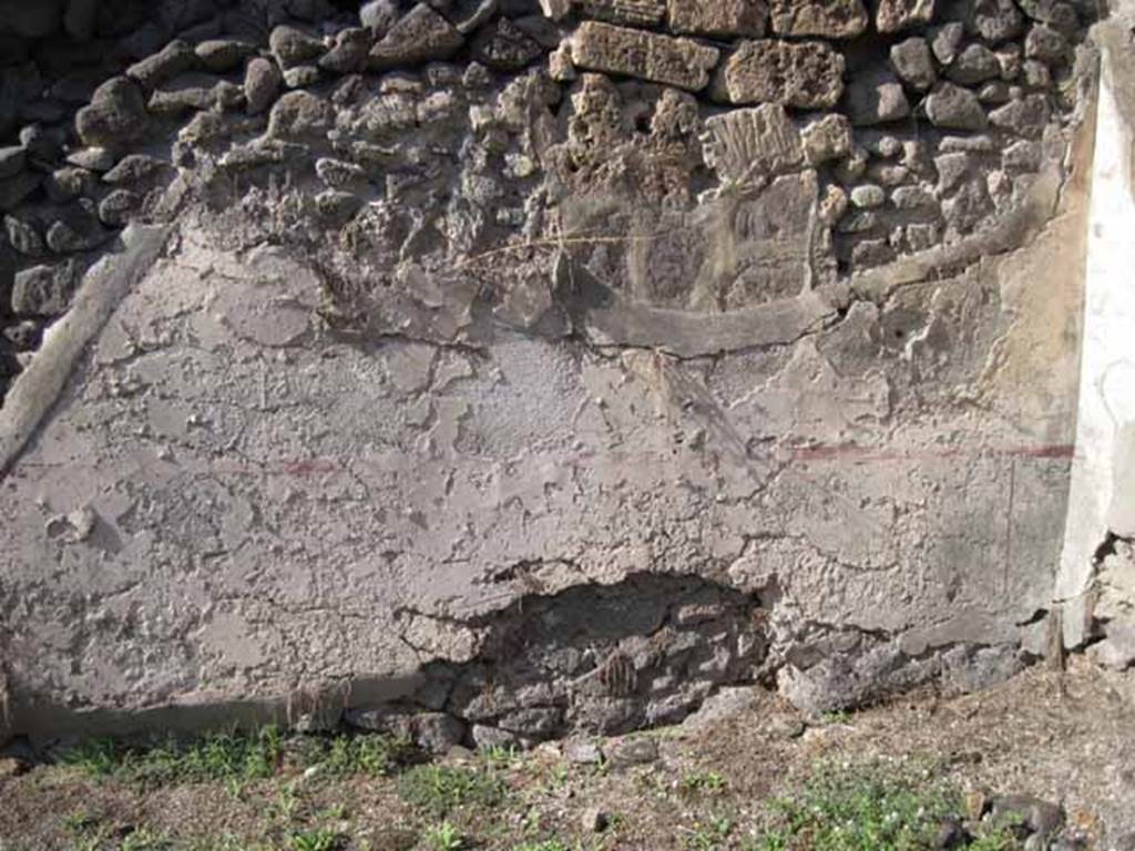 I.2.7 Pompeii. September 2010. North wall of rear room, with site of stairs on left. The wall (zoccolo and middle area) would have been painted white, panelled and compartmentalised by red painted lines (see corner area of north wall, on right).
Photo courtesy of Drew Baker.