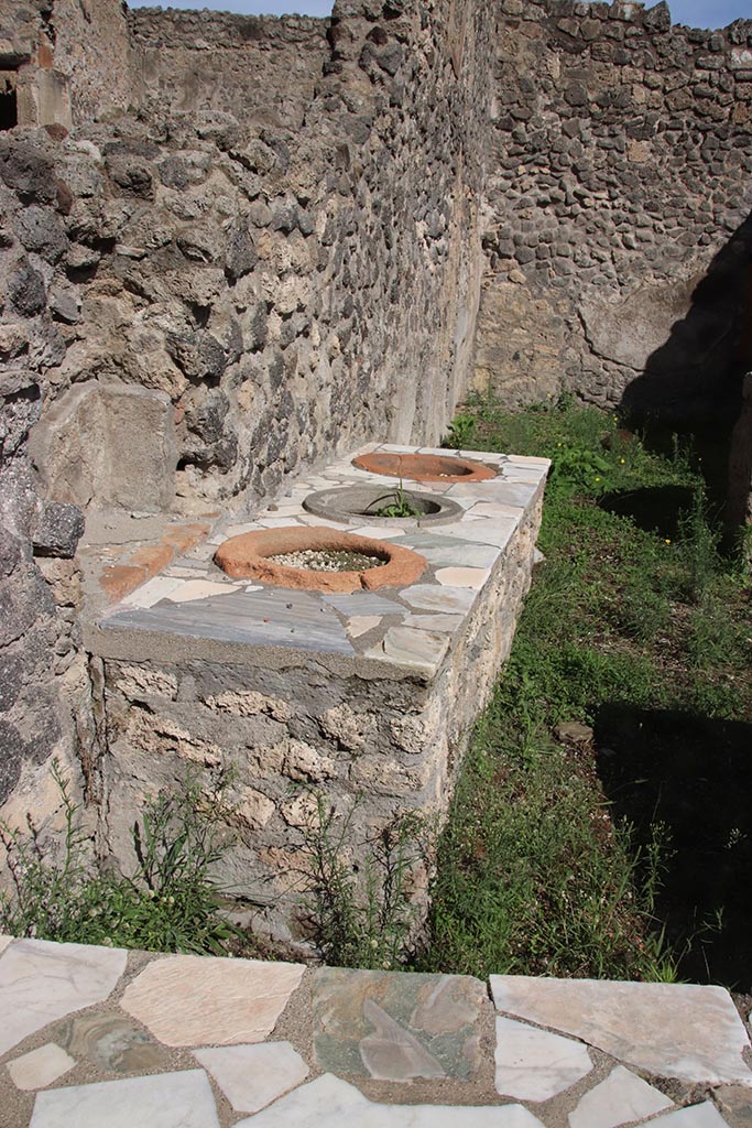 I.2.8 Pompeii. October 2024.
Looking east along north wall into rear room. Photo courtesy of Klaus Heese.