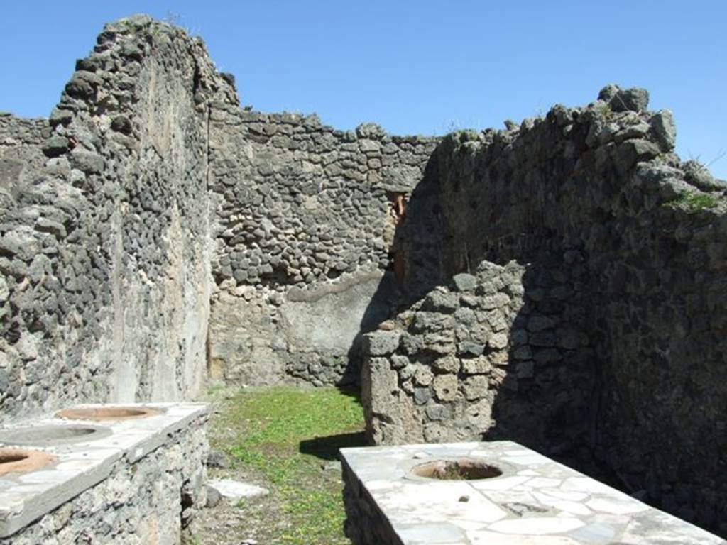 I.2.8 Pompeii. March 2009. Looking east to rear room.