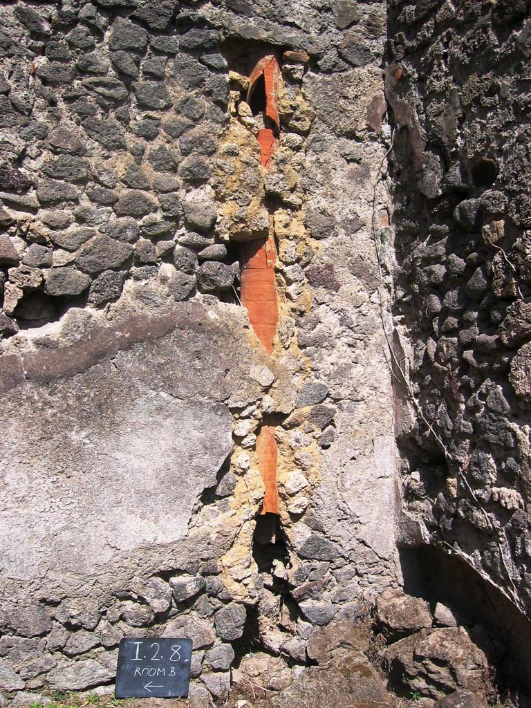 I.2.8 Pompeii. July 2008.
Down-pipe in east wall near south-east corner of rear room. Photo courtesy of Barry Hobson.