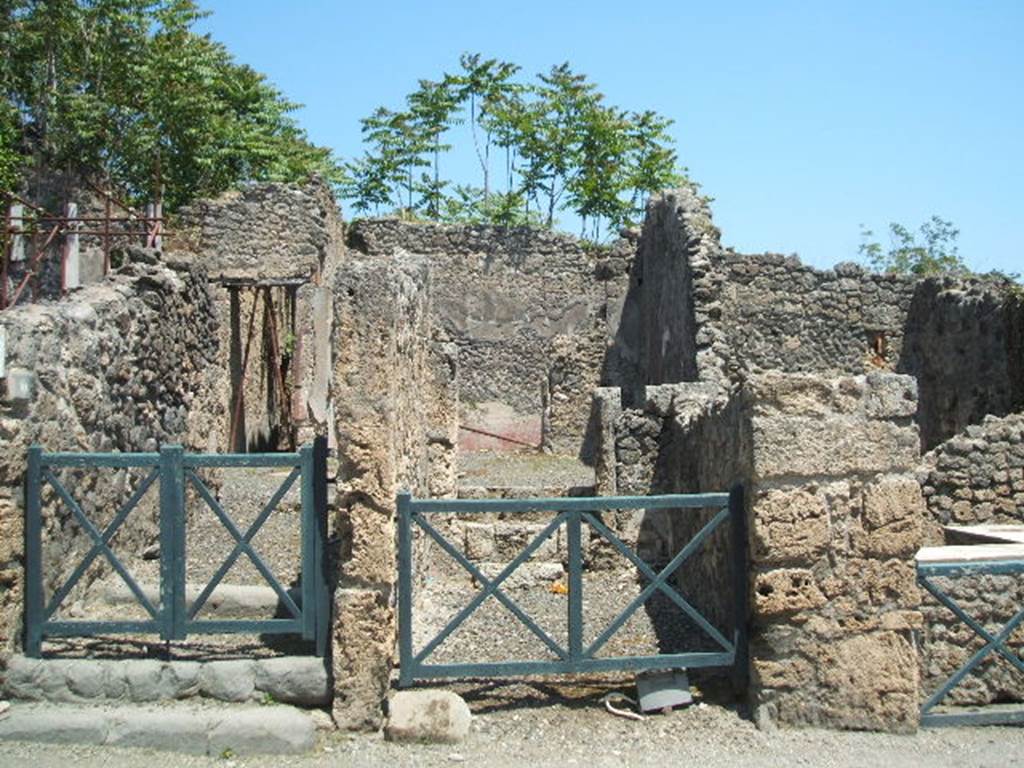 I.2.10 Pompeii, on left. May 2005. Looking east from Via Stabiana towards entrances. I.2.9, in centre.