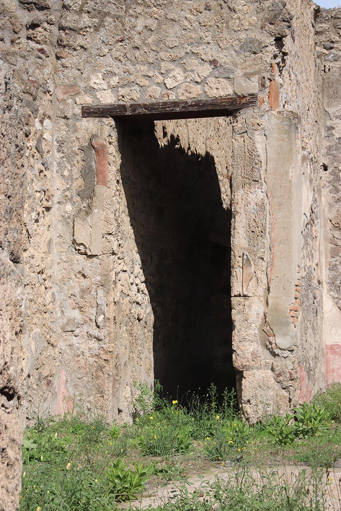 I.2.10 Pompeii. October 2024.
Looking towards doorway in east wall, into corridor leading to rear. Photo courtesy of Klaus Heese.