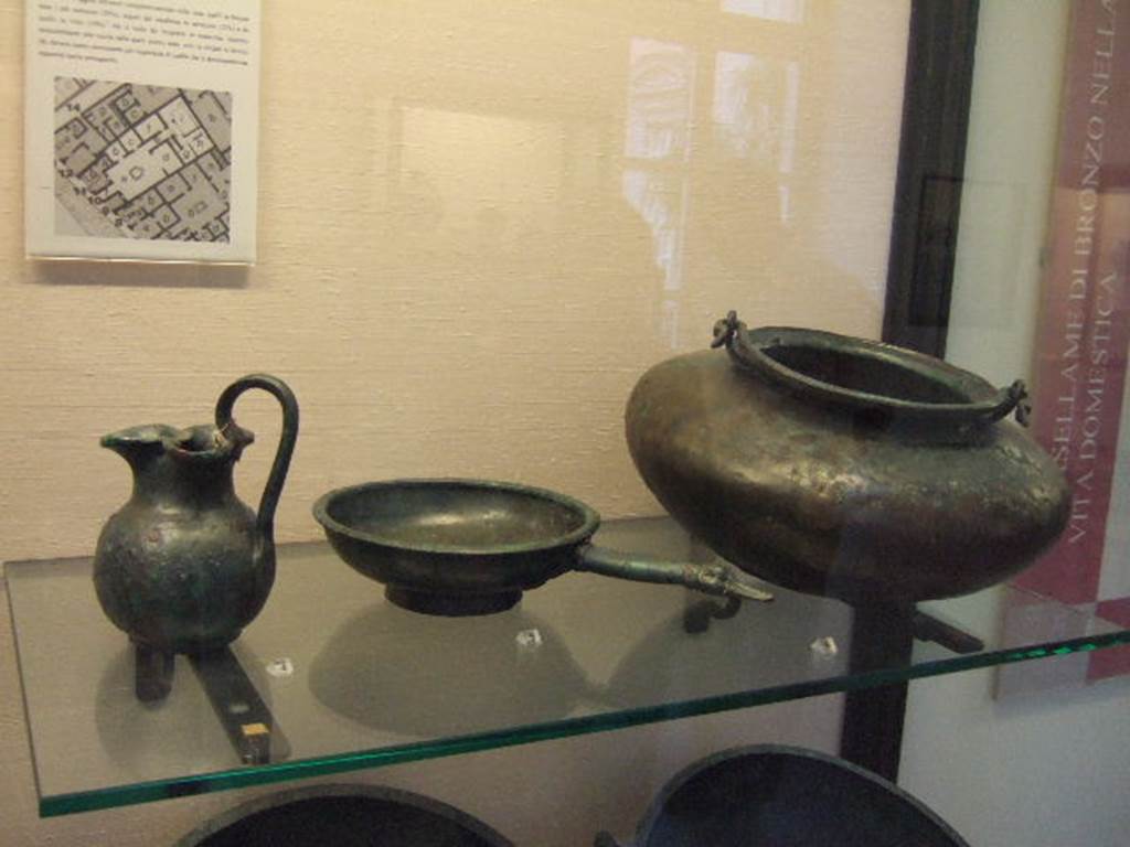 I.2.10 Pompeii. Found in cubiculum. Bronze jug. Now in Naples Archaeological Museum. Inventory number: 109816. Found in cubiculum. Bronze patera. Now in Naples Archaeological Museum. Inventory number: 109818. Found in atrium. Bronze cauldron. Now in Naples Archaeological Museum. Inventory number: 111545.