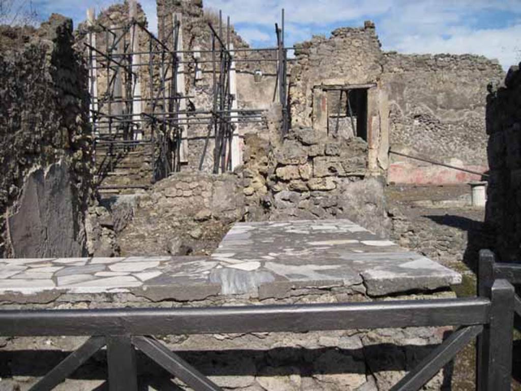 I.2.11 Pompeii. September 2010. Looking east across counter, from entrance doorway. Photo courtesy of Drew Baker.
According to Garcia y Garcia, originally there were three dolia and two display shelves in the sales counter. However, today it is smooth and level after its restoration following the September 1943 bombing.
