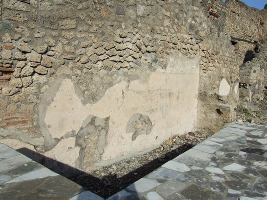 I.2.13 Pompeii. December 2007. North wall and area behind serving counter. At the far end is the entrance to I.2.14 which was an independent staircase to a dwelling above I.2.13.