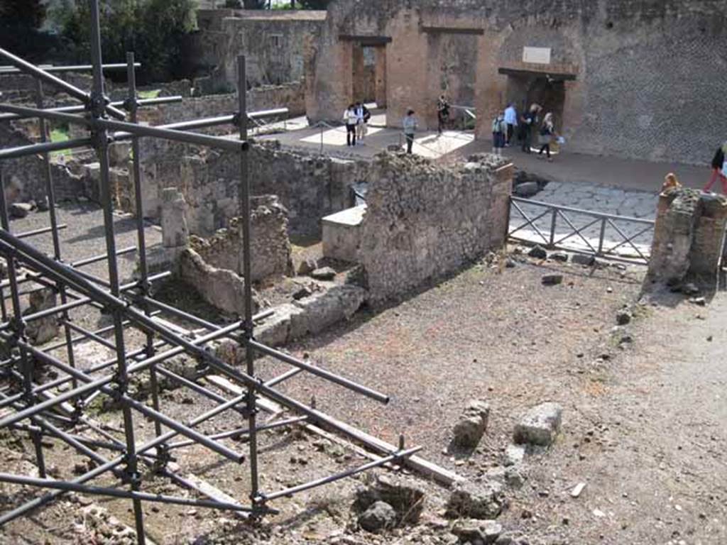 I.2.15 Pompeii. September 2010. Looking south-west from end of corridor on top of collapse. Photo courtesy of Drew Baker.
According to Garcia y Garcia, all the west part of the dwelling was completely destroyed in 1943. The bomb demolished the upper floor, leaving the cistern below uncovered and visible. See Garcia y Garcia, L., 2006. Danni di guerra a Pompei. Rome: L’Erma di Bretschneider. (p.37)