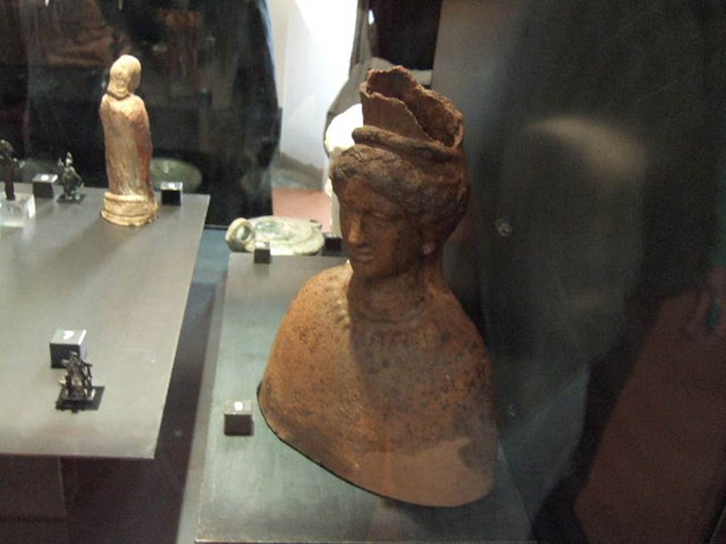 Terracotta bust of Isis found in I 2.17. Now in Naples Archaeological Museum.