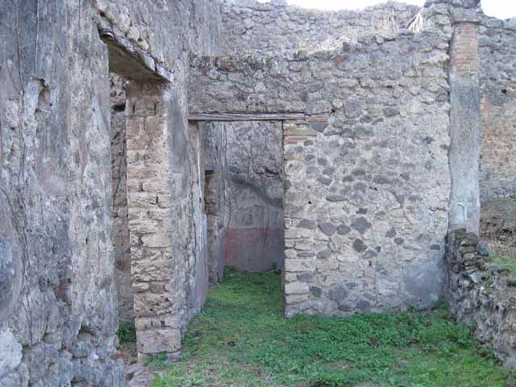 I.2.28 Pompeii. September 2010. Looking west across south portico, towards doorway to small room on south side of triclinium. Photo courtesy of Drew Baker. The doorway on the left leads from the tablinum.
According to Jashemski, the wall on the right would have had an entrance through the wall into the garden opposite the tablinum doorway. See Jashemski, W. F., 1993. The Gardens of Pompeii, Volume II: Appendices. New York: Caratzas. (p.25)
