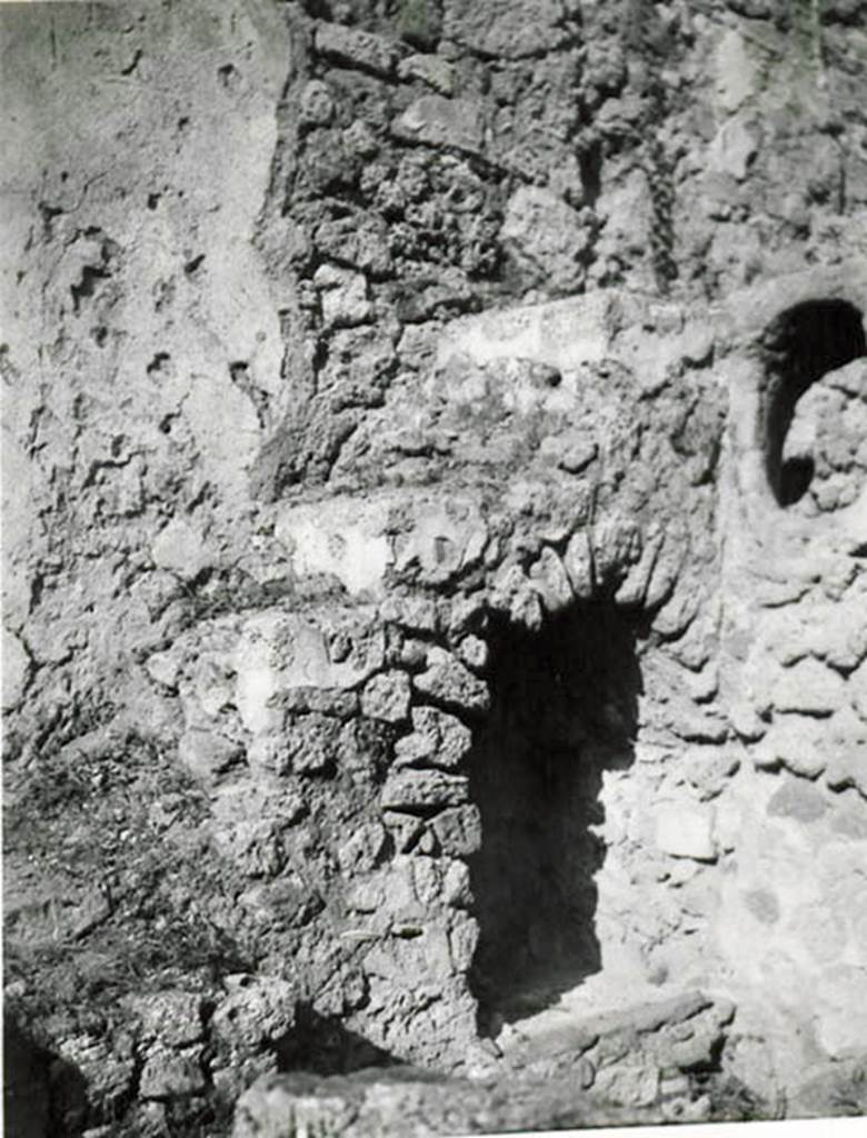 I.2.28 Pompeii. 1935 photo taken by Tatiana Warscher. North-east corner of garden area, with steps to upper floor and recess below.
See Warscher T., 1935. Codex Topographicus Pompeianus: Regio I.2. (no.57), Rome: DAIR, whose copyright it remains.
According to Warscher, “Il lato orientale del peristilio. La scala con sottoscala che conduceva al primo piano e la finestra ovale che illuminava la cucina “k”.
(translation: “The east side of the peristyle. The stairs with understairs, that lead to the first floor, and the oval window that lit the kitchen “k”.)
