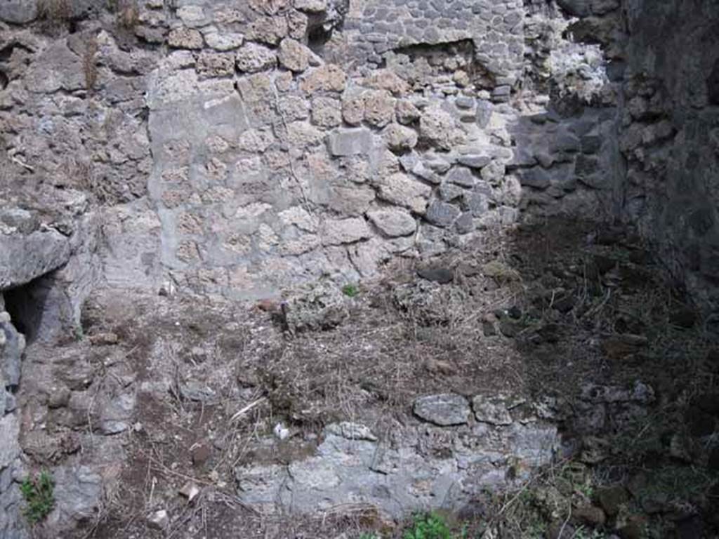 I.2.28 Pompeii. September 2010. East wall of kitchen area, with bench or hearth. The oven can be seen on the left of the photo. Photo courtesy of Drew Baker.