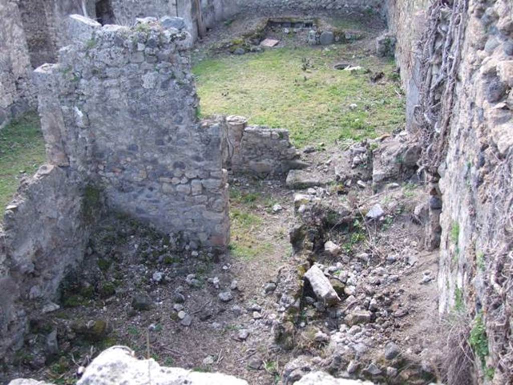 I.2.28 Pompeii. March 2009. Looking west above Kitchen area. Taken from I.2.20. According to Fiorelli, this comprised “an ample hearth, two rooms as cells, the latrine, a staircase to the floor above, and at the back of the portico a cupboard between two small masonry walls”. See Pappalardo, U., 2001. La Descrizione di Pompei per Giuseppe Fiorelli (1875). Napoli: Massa Editore. p.38