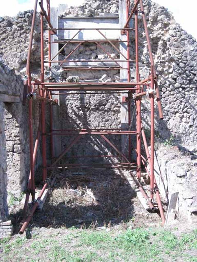 I.2.31 Pompeii. September 2010. Looking north from southern rear room towards the second rear room. A wall with a doorway leading from one to the other would have been across the photo at the front of the scaffolding.
Photo courtesy of Drew Baker.