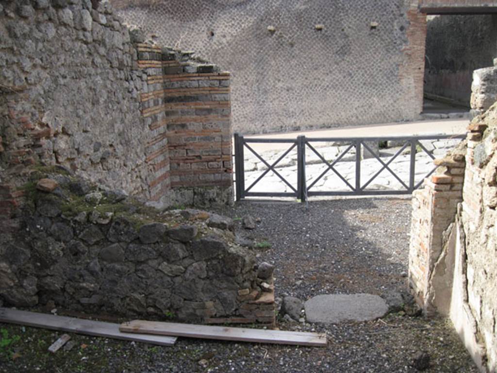 I.3.1 Pompeii. September 2010. West wall and doorway of small room, looking towards entrance from Via Stabiana, and west wall of bakery room. Photo courtesy of Drew Baker.