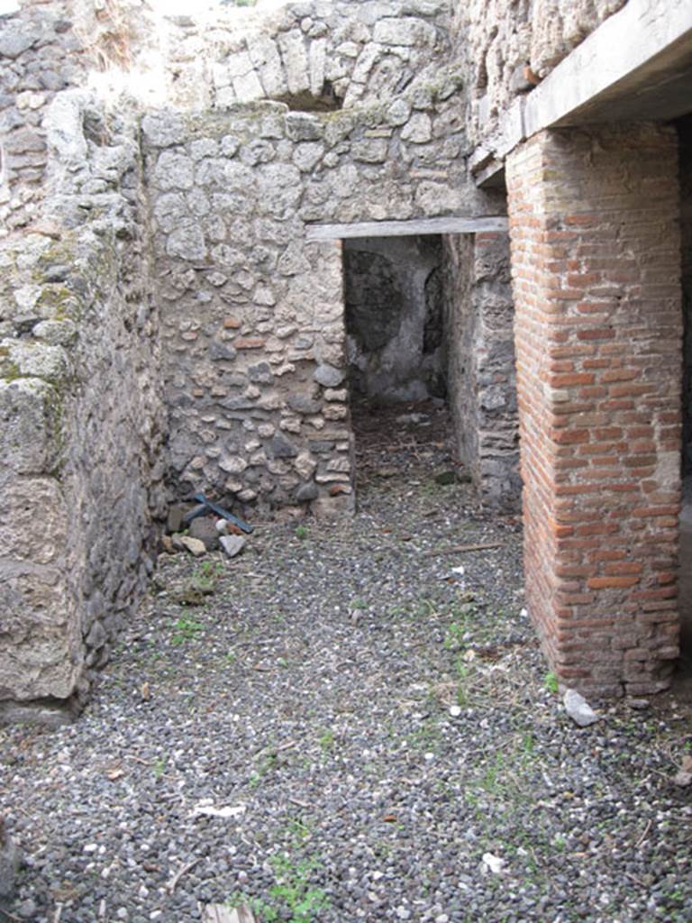 I.3.3 Pompeii. September 2010. Looking east across area of wider corridor, from north end of narrow corridor. On the left can be seen the doorway to the second triclinium, ahead is a doorway to an area that Fiorelli called “il repositorio”. On the right are the two doorways to the kitchen area. Photo courtesy of Drew Baker