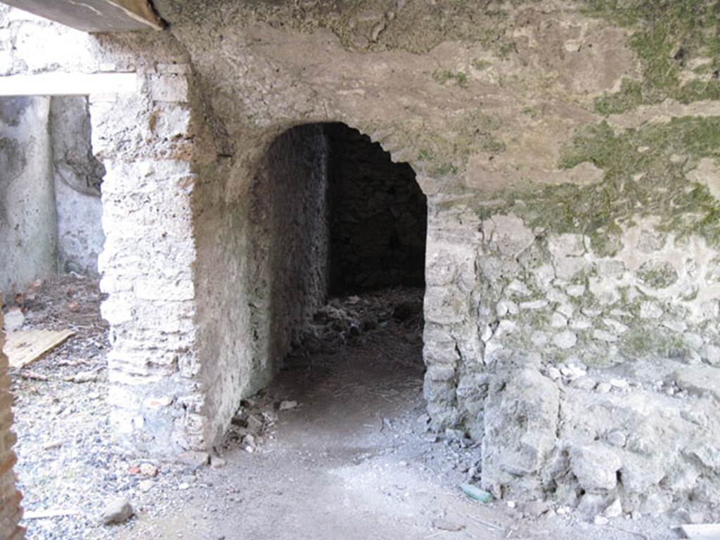 I.3.3 Pompeii. September 2010. Looking east in kitchen towards north-east corner and doorway through to two storerooms, that Fiorelli thought had originally been one large one.
On the left is the doorway towards the wider corridor. Photo courtesy of Drew Baker.