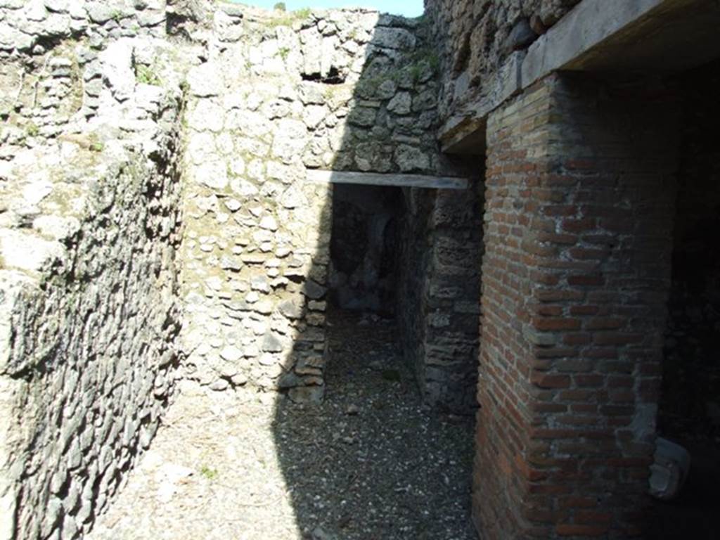 I.3.31 Pompeii. March 2009. Looking east along wider corridor below another corridor (now collapsed) in south-west corner of upper peristyle. According to Fiorelli, the upper corridor had a sloping floor.
