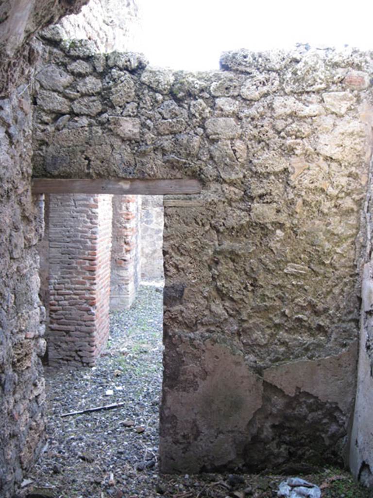 I.3.3 Pompeii. September 2010. West wall of small room, looking through doorway into wider corridor on north side of kitchen doorways. Photo courtesy of Drew Baker.