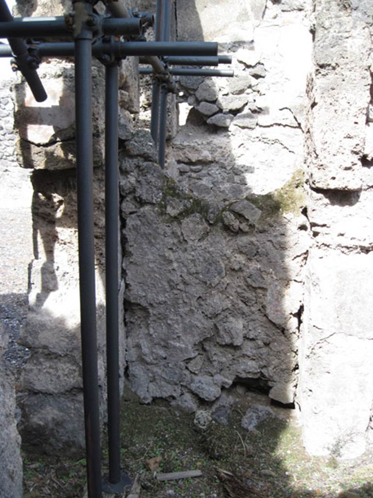 I.3.3 Pompeii. September 2010. North wall of second triclinium, with detail of blocked doorway in north-west corner. According to Mau, this blocked doorway led through to the stairway that lead up to the peristyle. See Mau, A: BdI 1874, (p.178-9). Photo courtesy of Drew Baker.