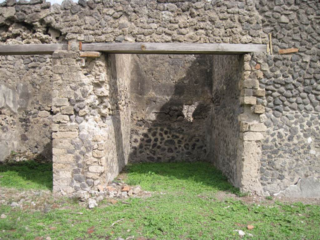 I.3.3 Pompeii. September 2010. Upper peristyle area, looking east to doorway to a small room which, according to Fiorelli and CTP, contained another staircase to access this side.
The staircase was to be found against the north wall of the room (on the left) near the pile of stones on the floor. Photo courtesy of Drew Baker.