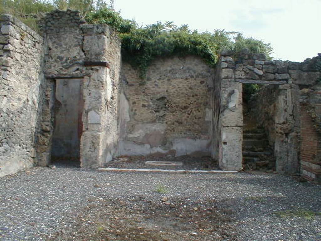 I.3.3 Pompeii. September 2004. Looking east across atrium to doorways to triclinium, tablinum and steps to upper floor.