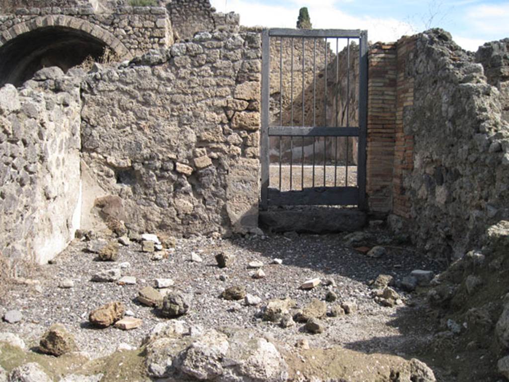 I.3.4 Pompeii. September 2010. Looking towards the eastern wall and doorway into I.3.3, from the entrance doorway. Photo courtesy of Drew Baker.