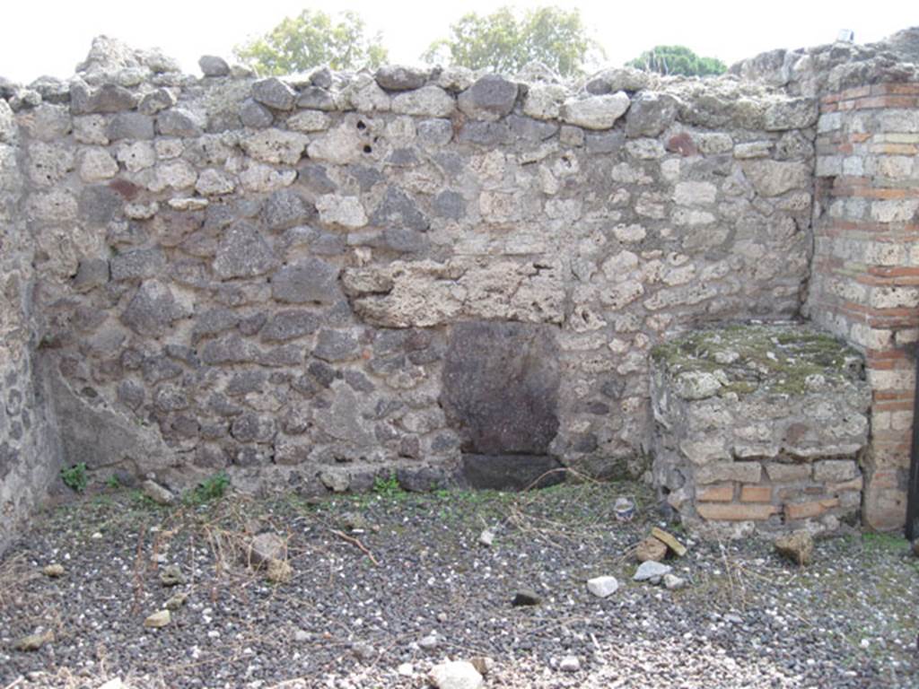 I.3.7 Pompeii. September 2010. South wall of shop, with brick podium in south-west corner.
Photo courtesy of Drew Baker.