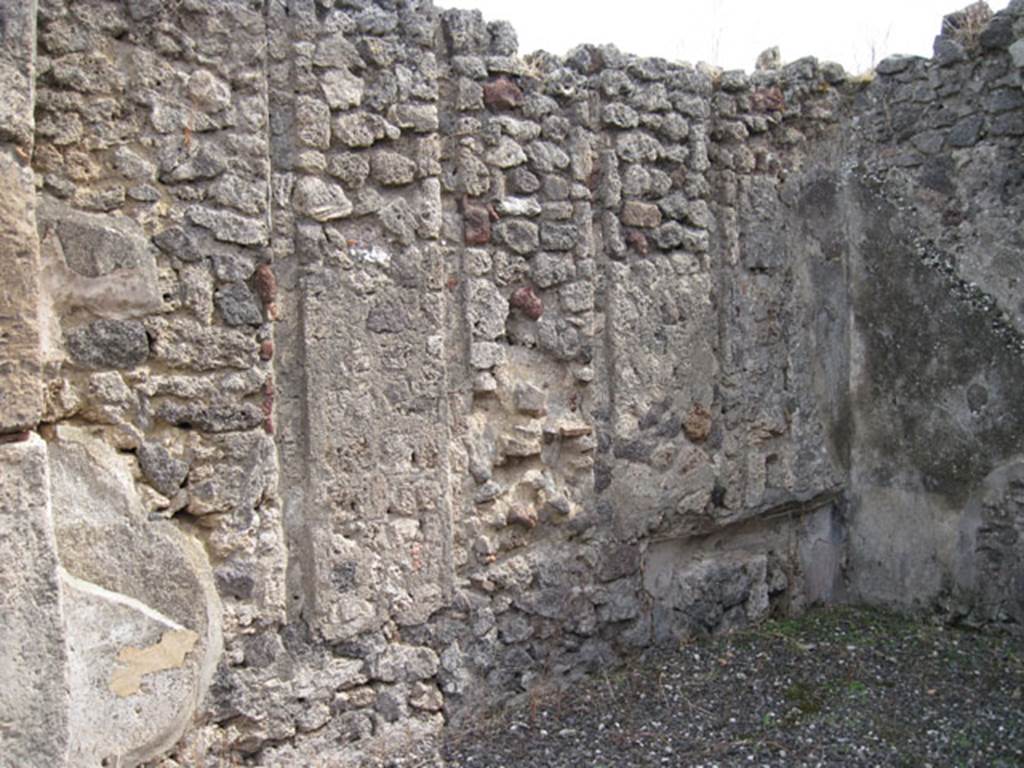 I.3.8b Pompeii. September 2010. East wall and south-east corner. Note vertical slot features corresponding to west wall of previous room, and couch recess. Photo courtesy of Drew Baker