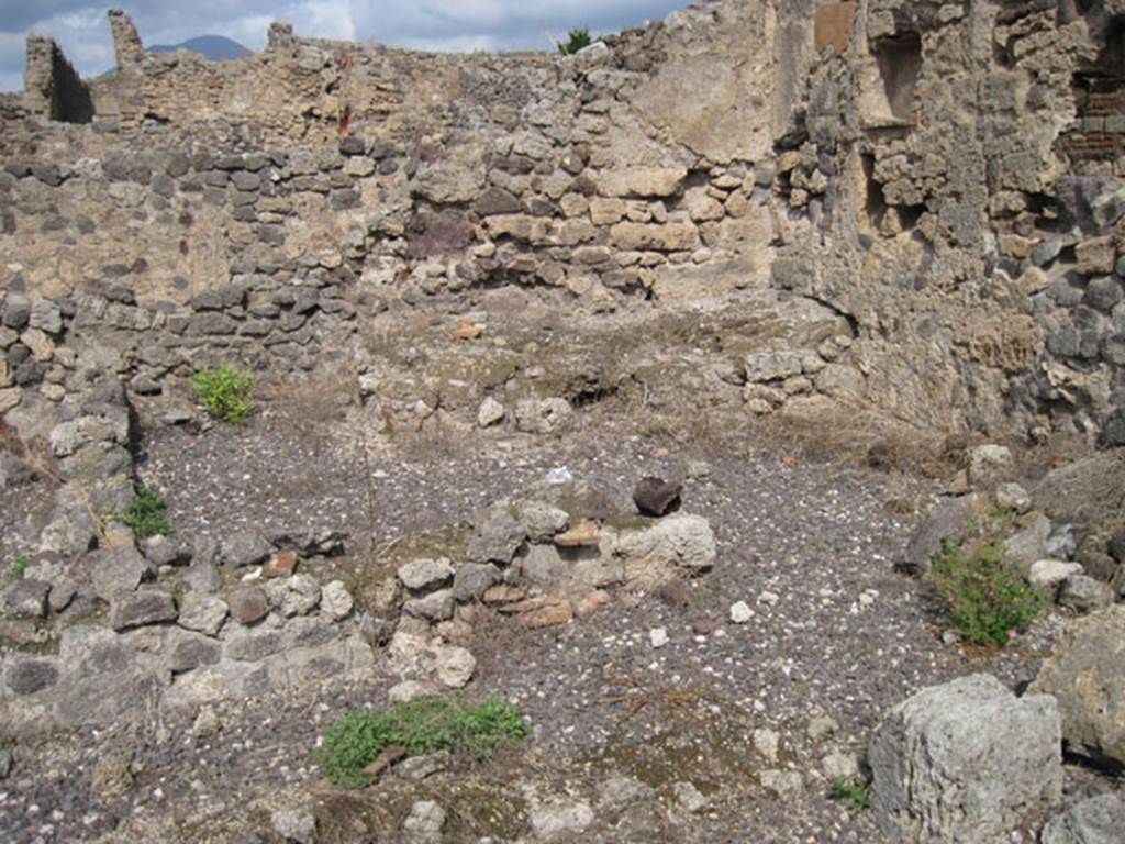 I.3.8a Pompeii. September 2010. Looking north along east side, towards kitchen or room in north-east corner. The doorway leads into the kitchen, with remains of hearth and niche in east wall. Photo courtesy of Drew Baker.