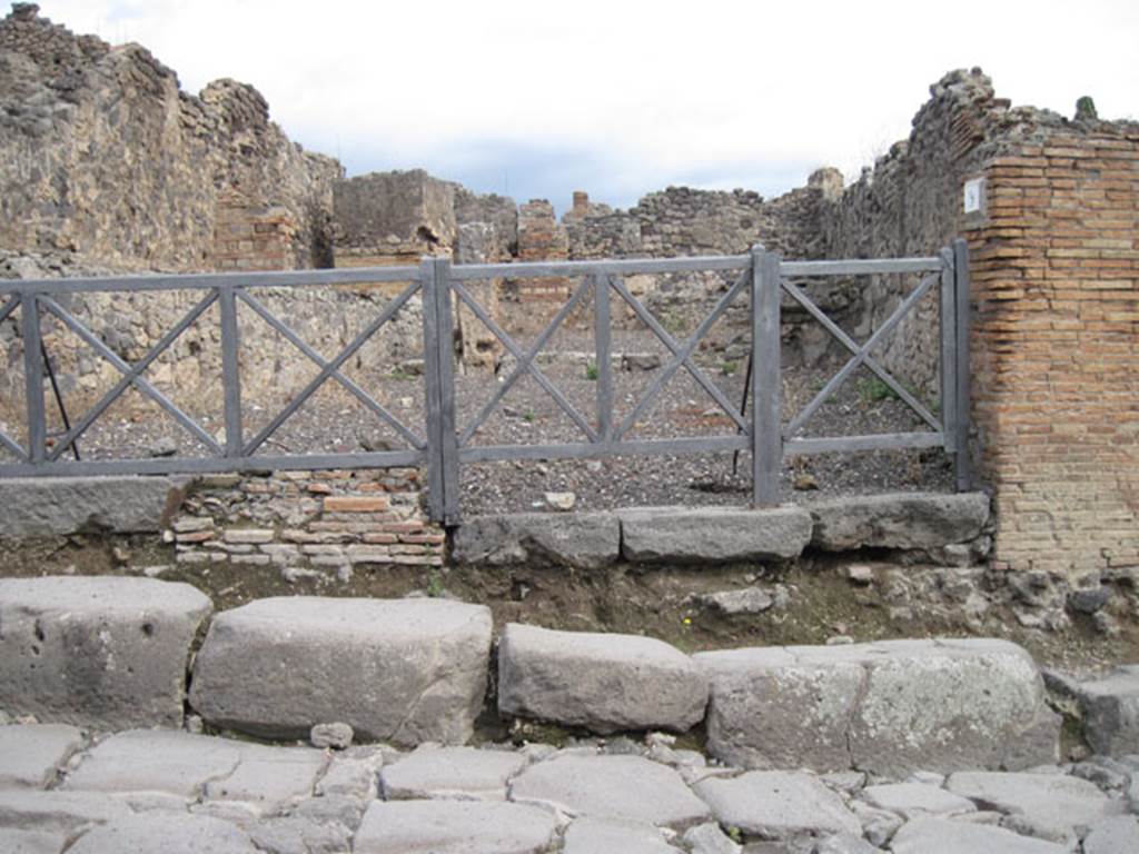 .3.9 Pompeii. September 2010. Looking east across Via Stabiana towards the entrance doorway. The main shop room at the rear of the doorway on the right, would have connected with the rooms in I.3.10. Photo courtesy of Drew Baker.