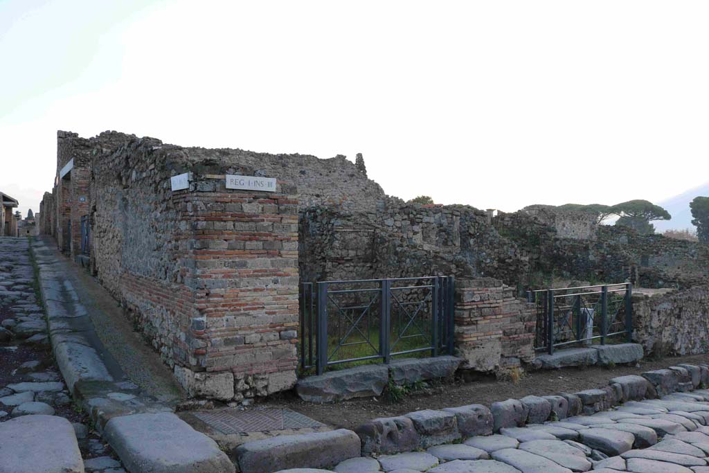I.3.12 Pompeii, in centre. December 2018.
Looking east towards entrance doorway on corner of Via Stabiana and its junction with Vicolo del Menandro. Photo courtesy of Aude Durand.