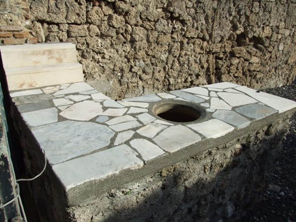 I.3.22 Pompeii. December 2007. Marble counter with two shelves for standing drinking vessels on and hole for a terracotta urn.