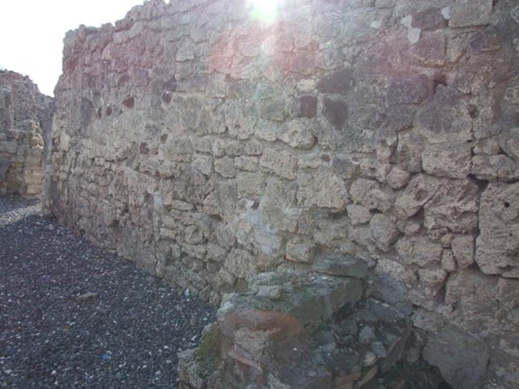 I.3.22 Pompeii. December 2007. West wall. At the front, on the right, are the remains of the staircase at I.3.21 which led to the upper storey of I.3.22. At the rear, on the left, is a doorway linking to I.3.20.