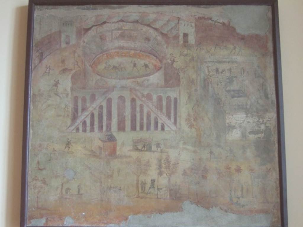 I.3.23 Pompeii. Rear wall of the peristyle. Painting of “Riot in the Amphitheatre” depicting the fight between the Nucerians and the Pompeians.
Now in Naples Archaeological Museum. Inventory number 112222.
The famous episode narrated by Tacitus outlined what happened in Pompeii in 59 BC, when a brawl broke out in the amphitheatre during a gladiator show that led to an armed clash.
The event drew the attention of Emperor Nero, who ordered the Senate in Rome to investigate the incident.
Following an inquiry by the consuls, reports Tacitus, Pompeii residents were banned from holding gladiator shows for 10 years, illegal associations were dissolved and the organizer of the games - former senator from Rome, Livineio Regulo - and all the others who were found guilty of incitement were exiled.
In 2017 a new tomb SG6 was found at Porta Stabia with a 4 metre long inscription, which completes the information of Tacitus, it refers for the first time to the exile that would hit even the two top magistrates in office, the duoviri of the city.
Before now, the Tacitus passage, a fresco in the house of Actius Anicetus and three graffiti found on walls at Pompeii were the only explicit references to the amphitheatre riot of 59.
The funerary inscription adds a key piece of information about this event.
Thanks to the deceased’s personal relationship with Nero, he was able to persuade him to allow the two duoviri exiled as punishment for the brawl to return to Pompeii.
This is the only reference to the duoviri having been exiled as well as the only reference to the intercessionary role the tomb occupant played.
It opens up the possibility that he was involved in the softening and lifting of the 10-year ban on public events at the amphitheatre.
It’s known that some combat spectacles like animal hunts took place during the first three years of the ban, and it was lifted entirely in 62 A.D. to celebrate the restoration of the amphitheatre after the earthquake.
The inscription therefore provides unpublished data on an important moment in Pompeii's political and institutional history, confirming the scenario of a nasty intrigue only outlined by Tacitus.
It is possible this was the tomb of Cn. Alleius Nigidius Maius, one of the most prominent characters of the Nero-Flavian era who is repeatedly acclaimed in Pompeii as a prolific provider of games, indeed he can be said to have been the best-known among the gladiatorial impresarios of the city.